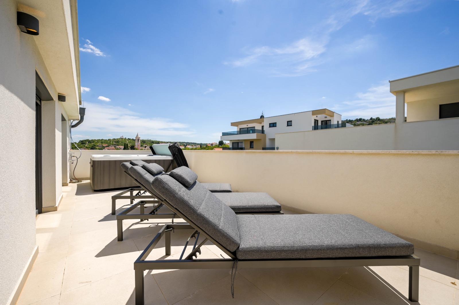 Three sun loungers on the terrace