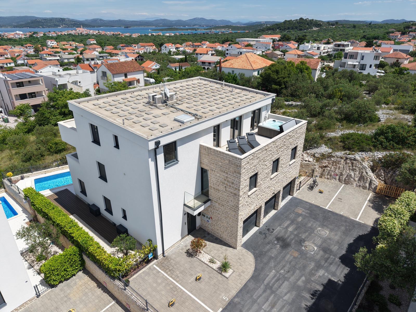 Modern white apartment building with rooftop terrace