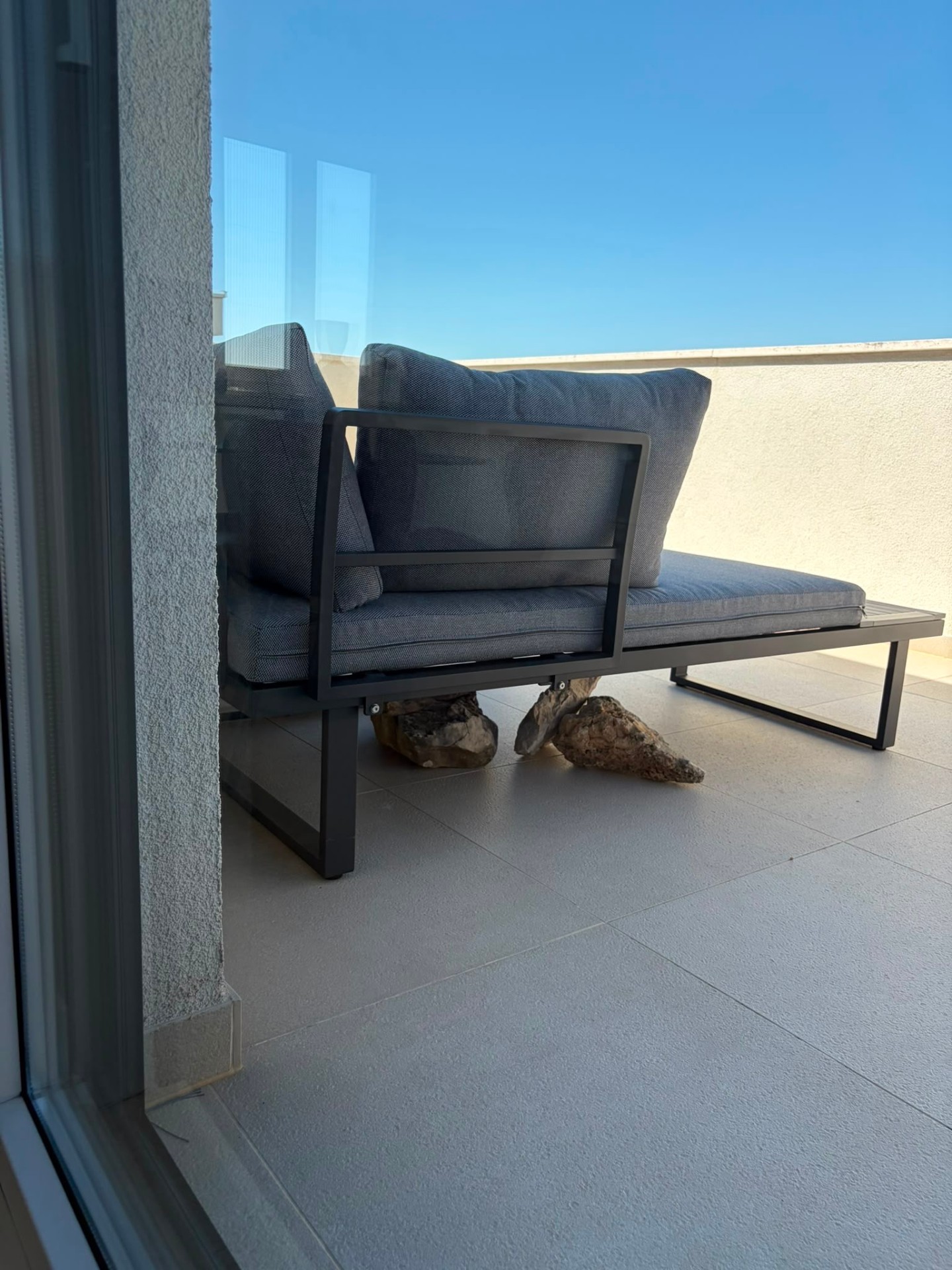 Outdoor lounge with sea beyond