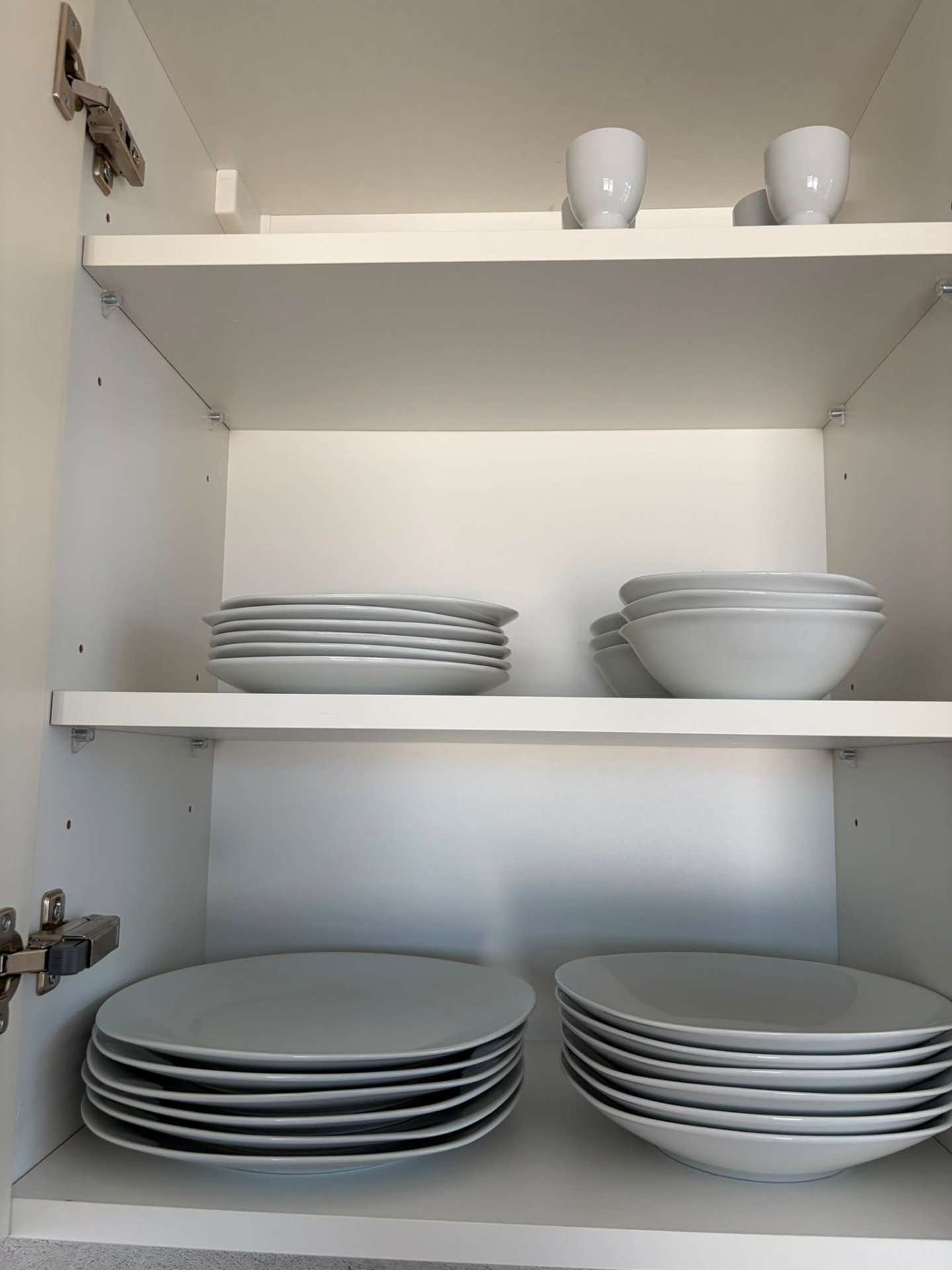 Plates and bowls stocked in the cupboard