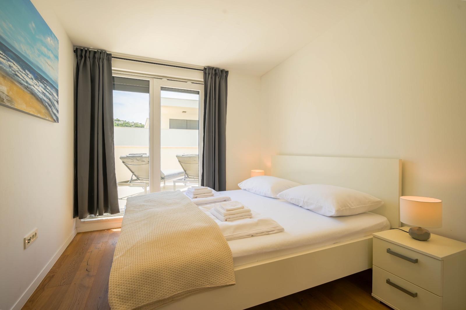 Double bedroom with glass terrace doors