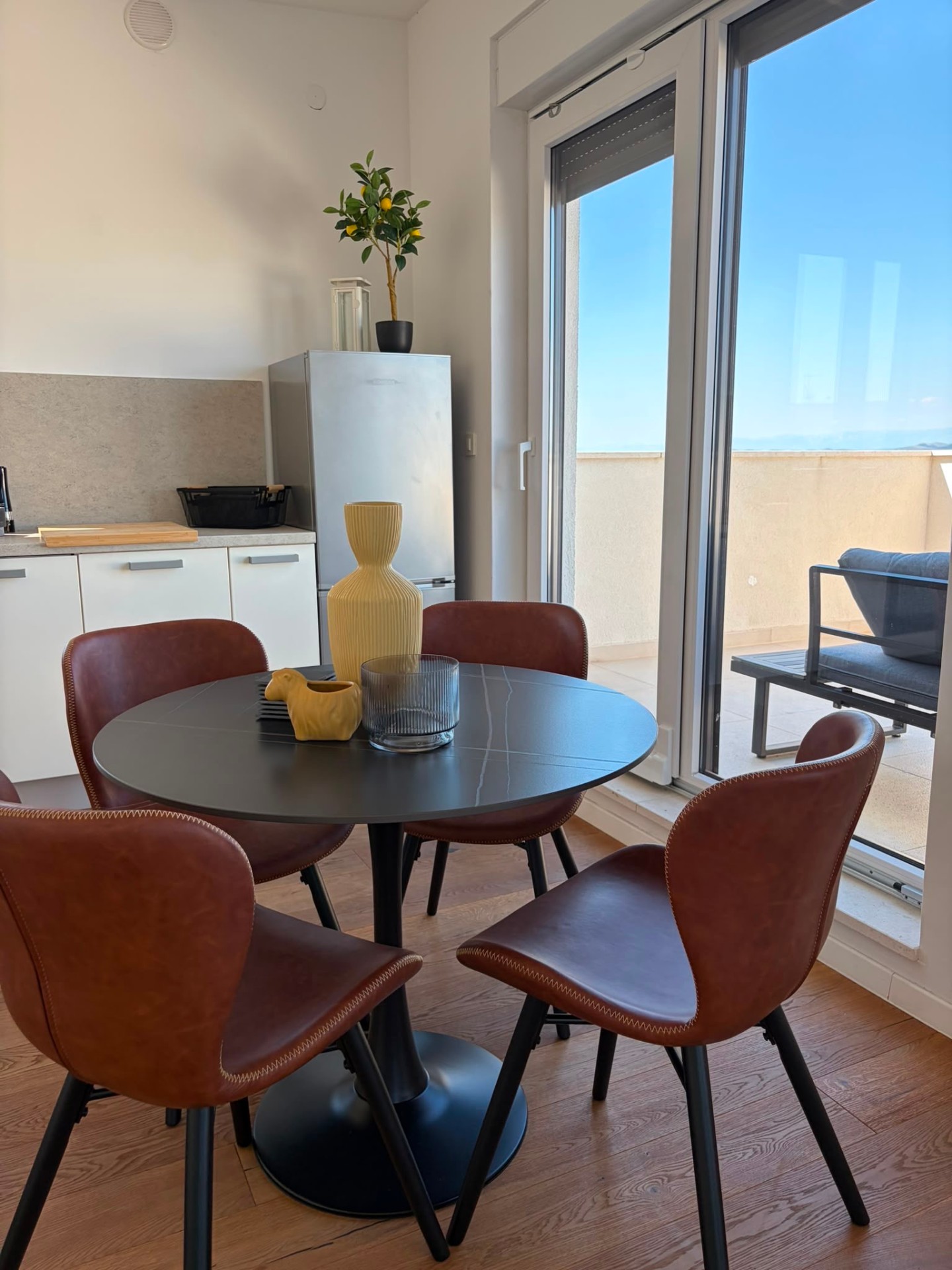 Round dining table with brown chairs